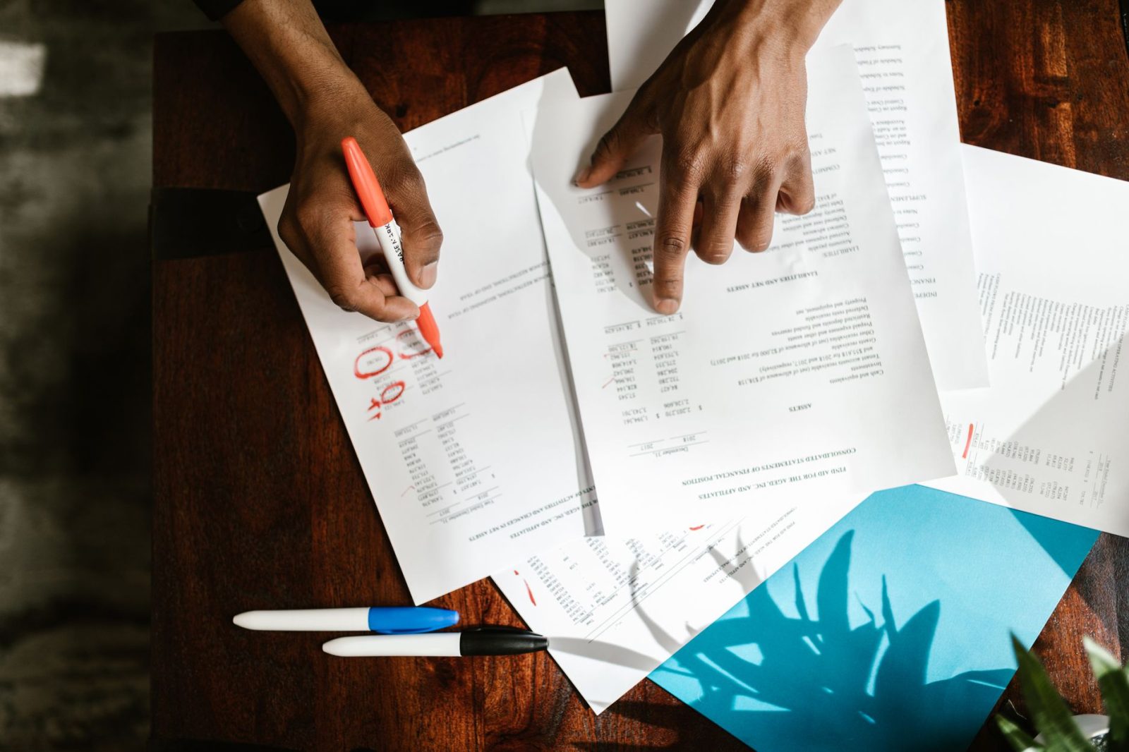 Hands going through paperwork on a desk