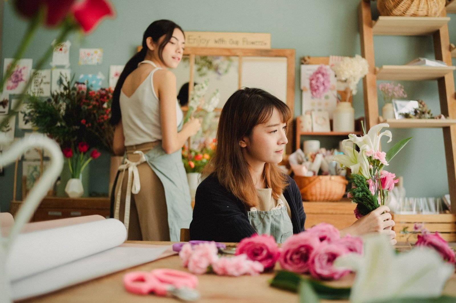 A florist arranging a bouquet in her shop