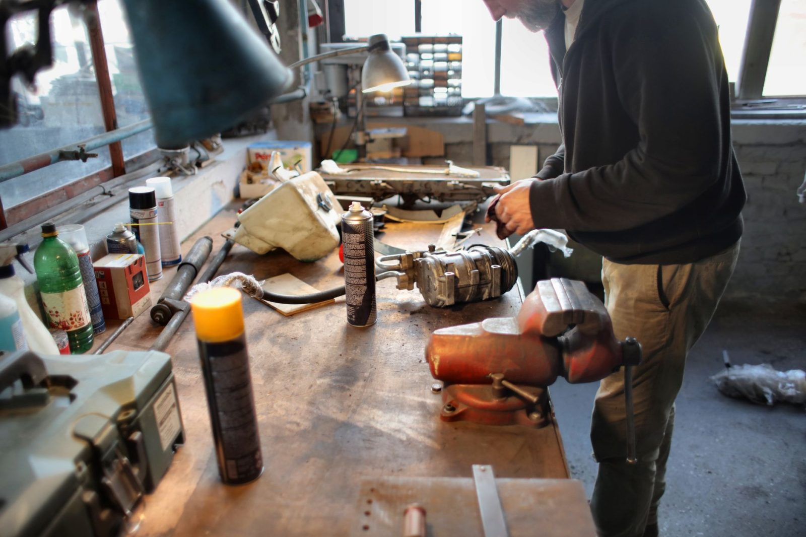 A mechanic repairing machinery in a workshop